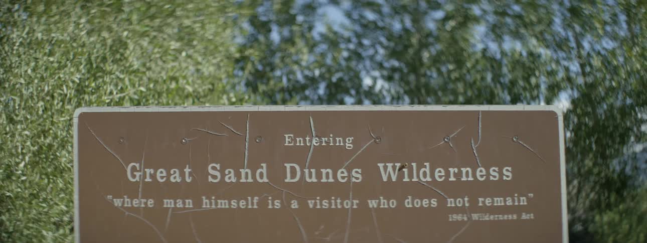 Reading an entry sign to a wilderness park