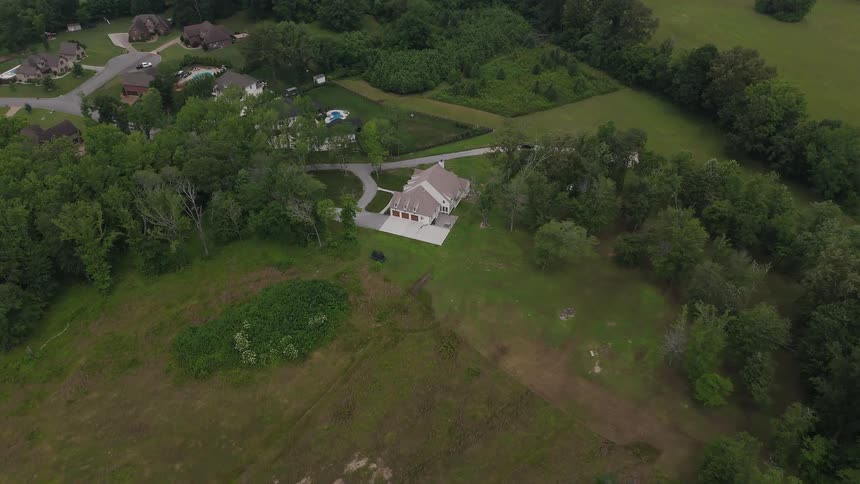 The home is surrounded by green