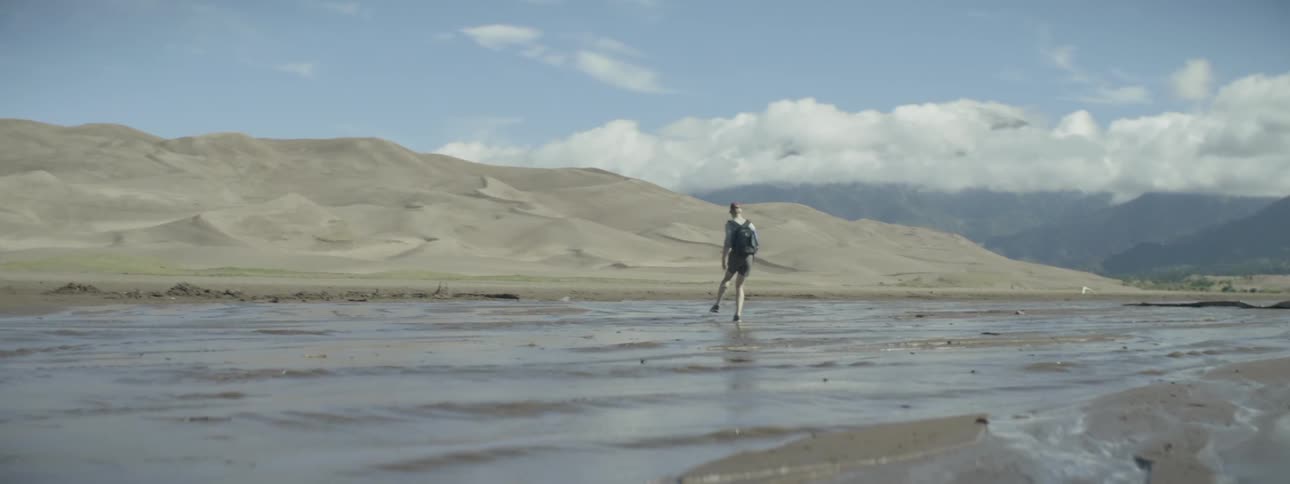 Man walking on wet sand in nature