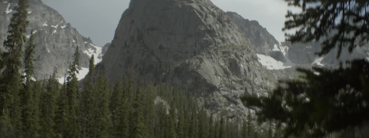 A rocky mountain peak is shown in the distance