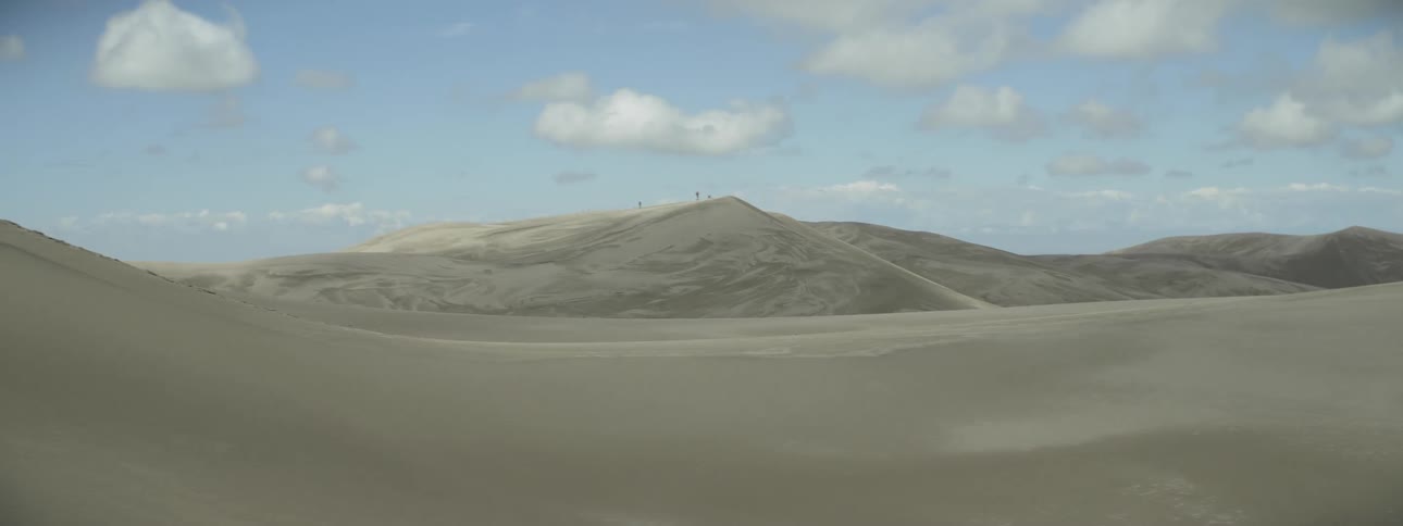 Sandy hills are shown in the distance