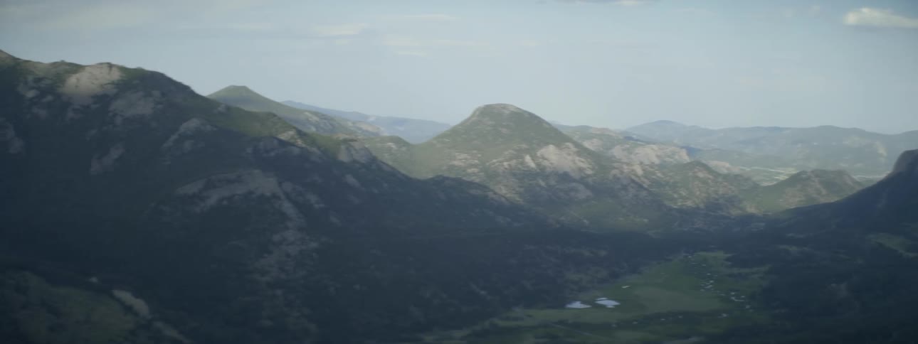 There is light fog over the mountains ahead