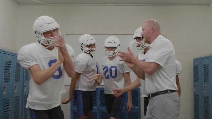 The team huddle with the couch in the locker room