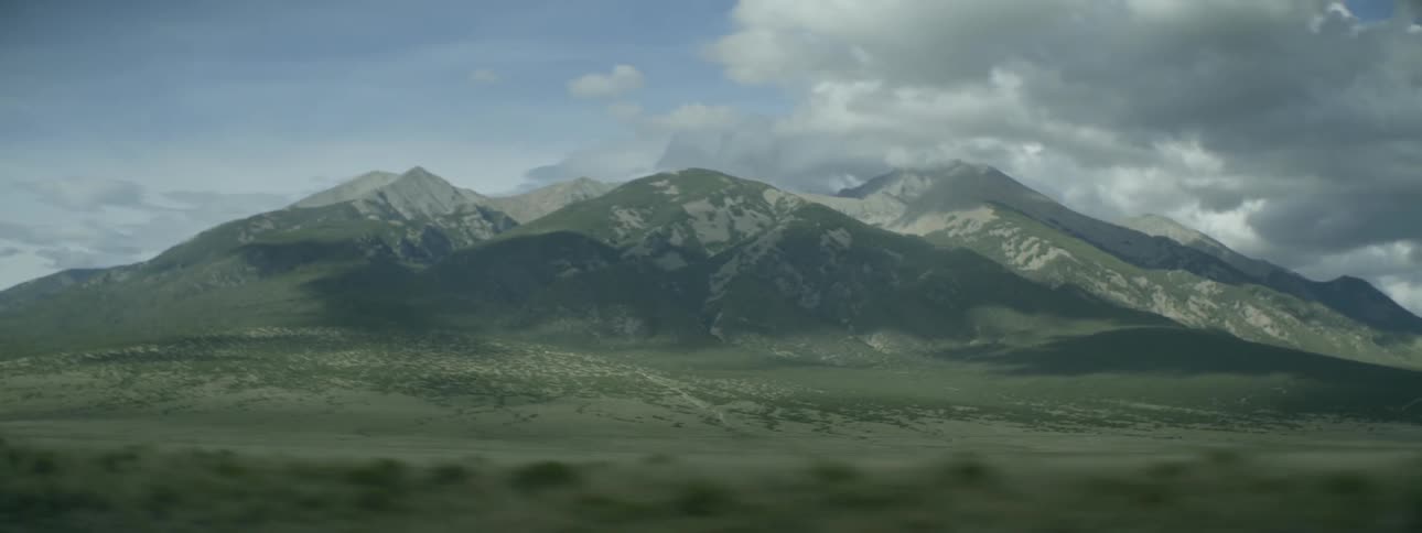 Tall mountains are touching the clouds ahead