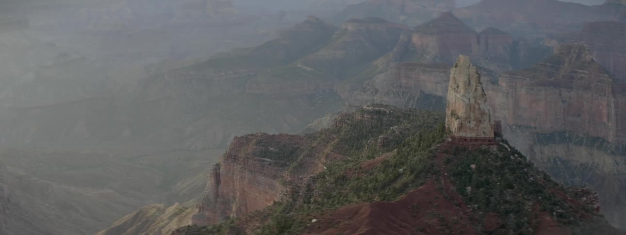 The mountains are covered with fog and green