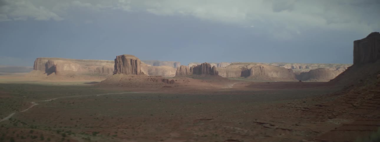 A long field leads to a mountain range ahead