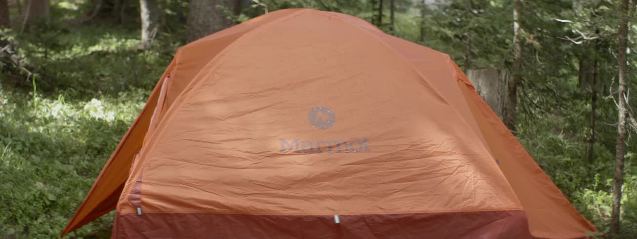 A orange tent is set for camp