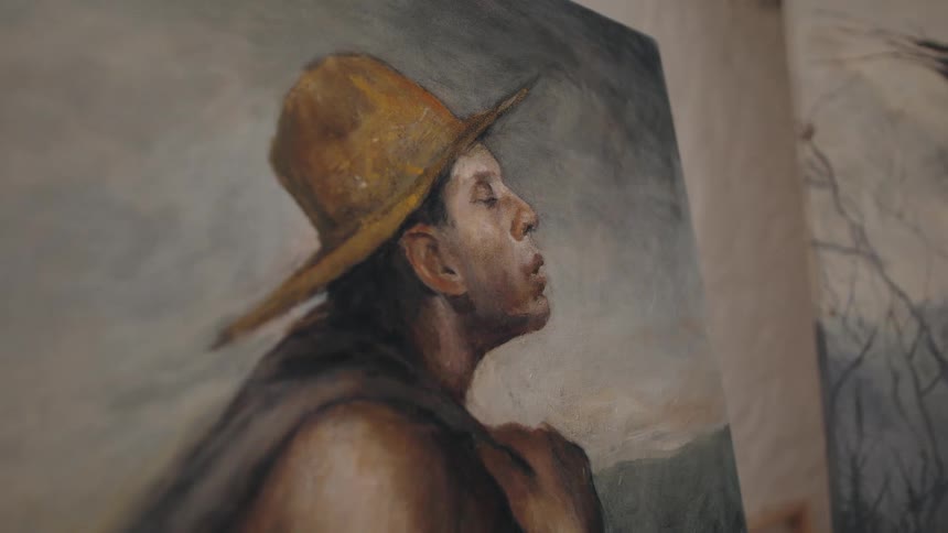 Portrait of a man with a yellow hat painted in earthy tones
