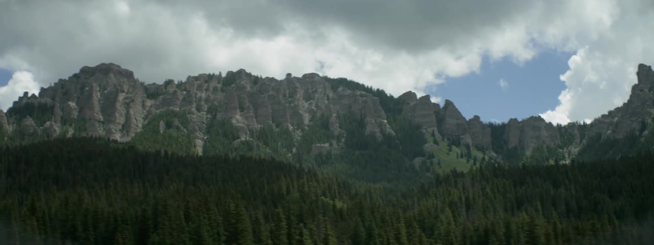 View of tall rocky cliffs on a cloudy day