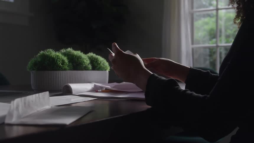 A woman organizes paperwork