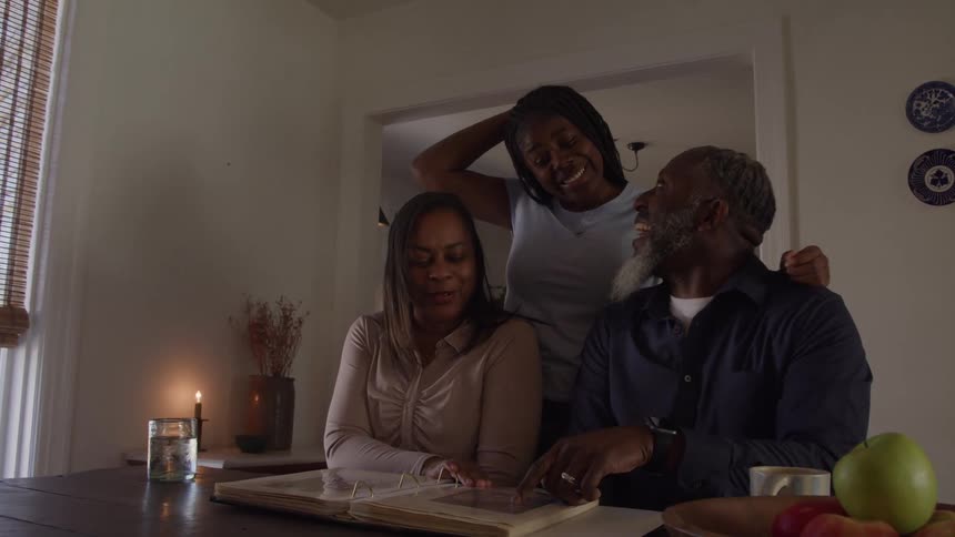 A family happily looks through a photo album
