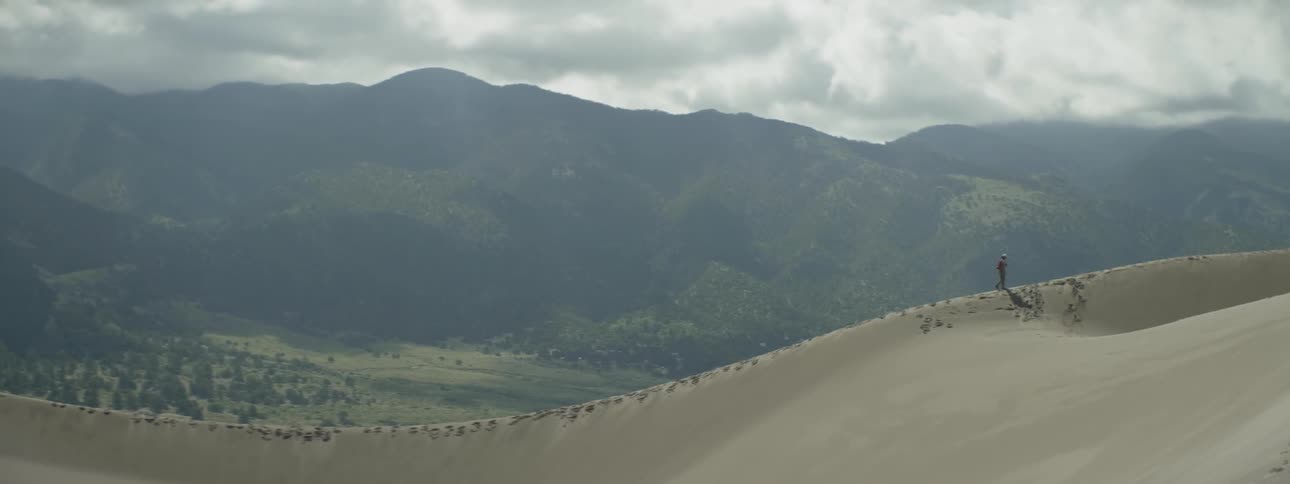 A person walks along a mountain ridge