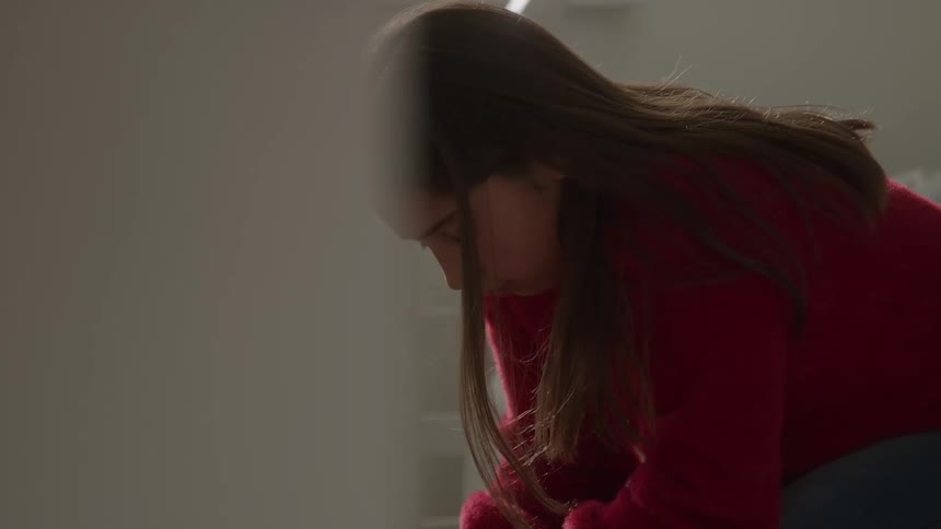 The woman looks sad as she leans forward