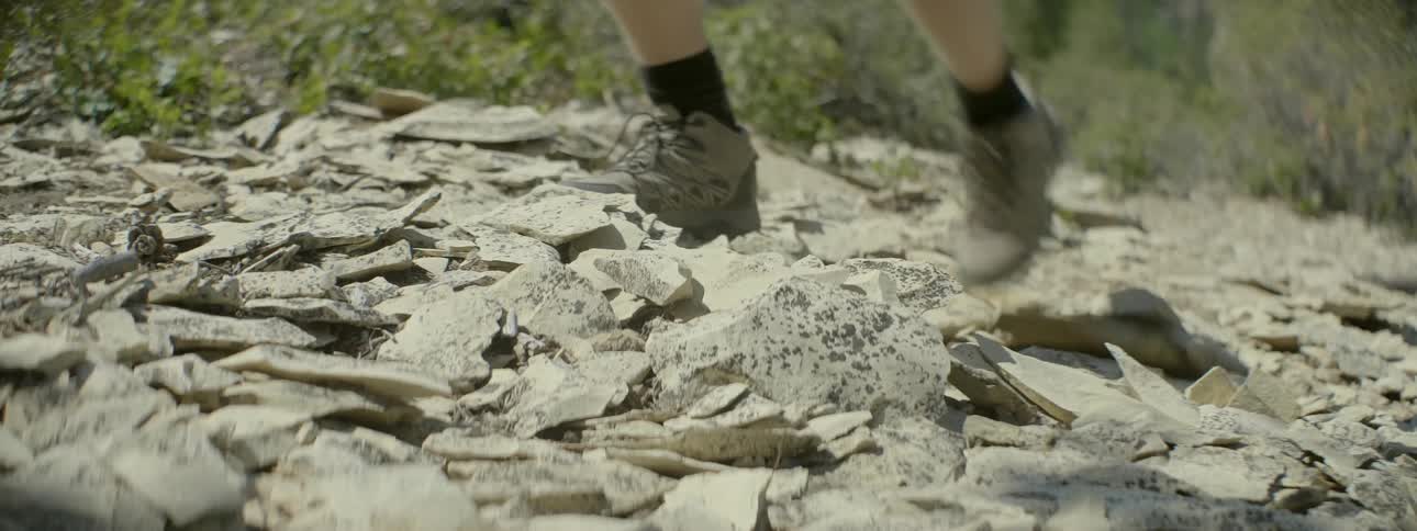 A person walks over chunks of rocks