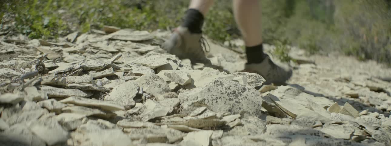 Person walking over rocky landscape