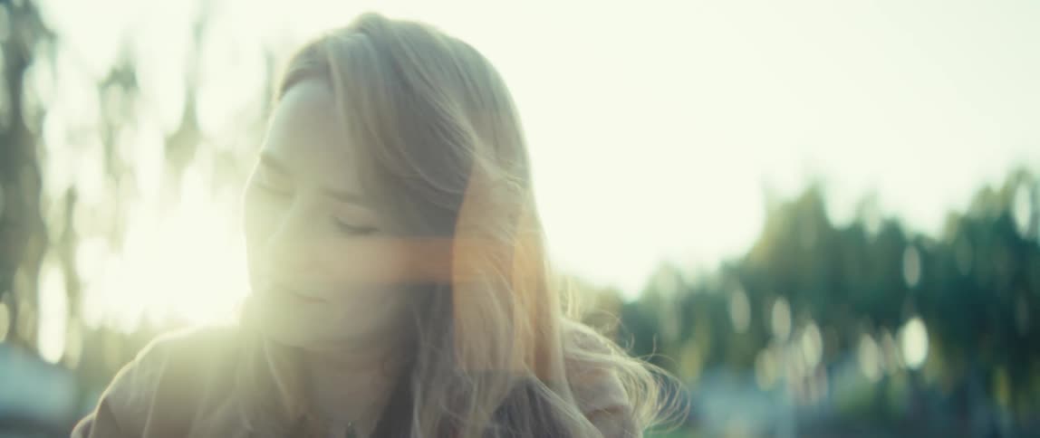 Woman gazing thoughtfully outdoors