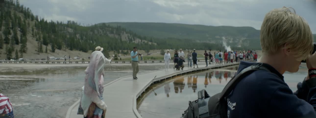 Tourists take photos from a platform in a scenic area