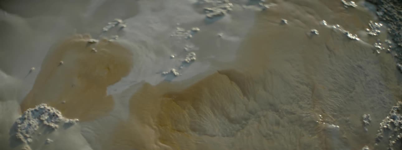 The sand is wet with water flowing over it