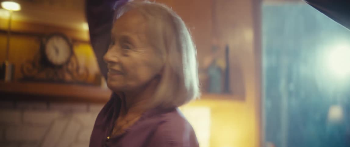 Elderly couple dancing happily in the living room