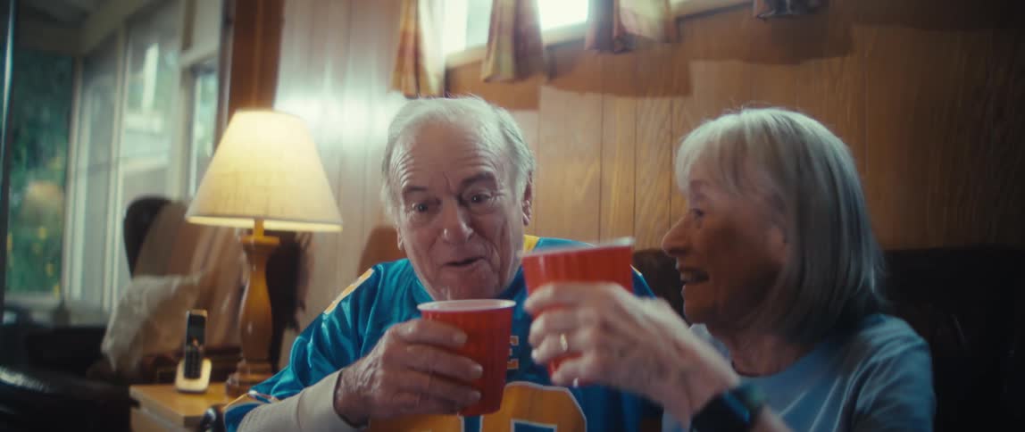 A man and woman are toasting and drinking with cups