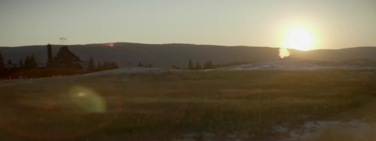 The sun sets over a rural field