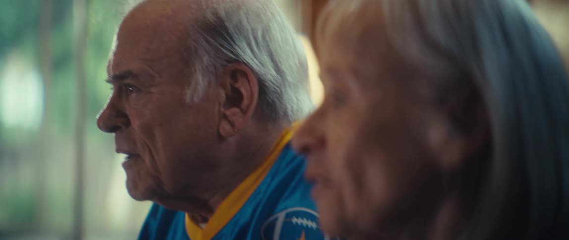 A man and woman are side by side and talking