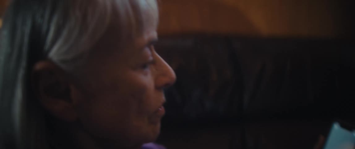 Elderly woman focused on using a cell phone