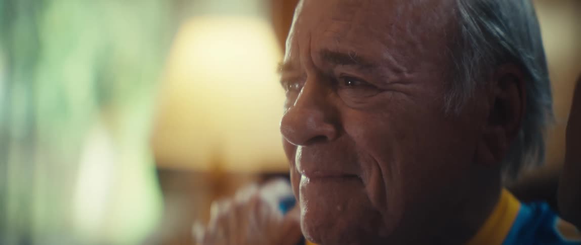 Elderly man emotionally comforted by another person
