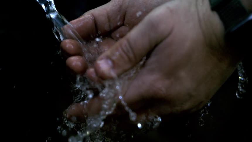 Hands cupped gathering running water