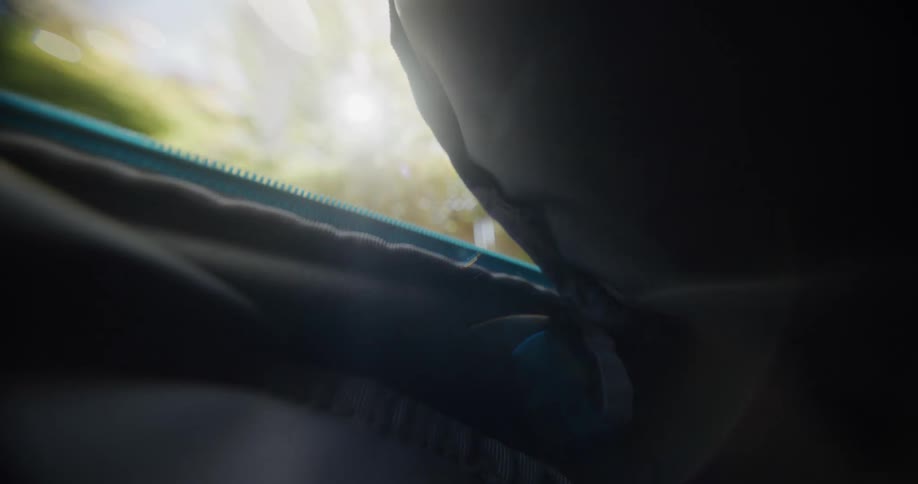 A bag being zipped open seen from within