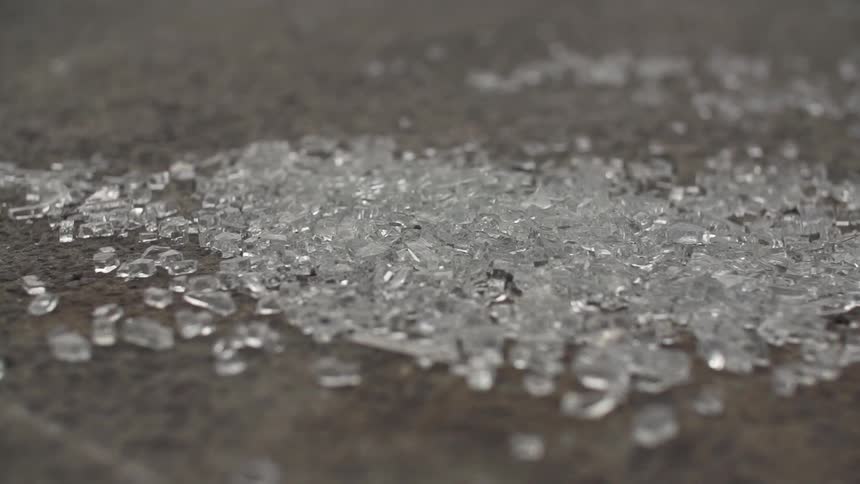 Shattered glass lays on the ground