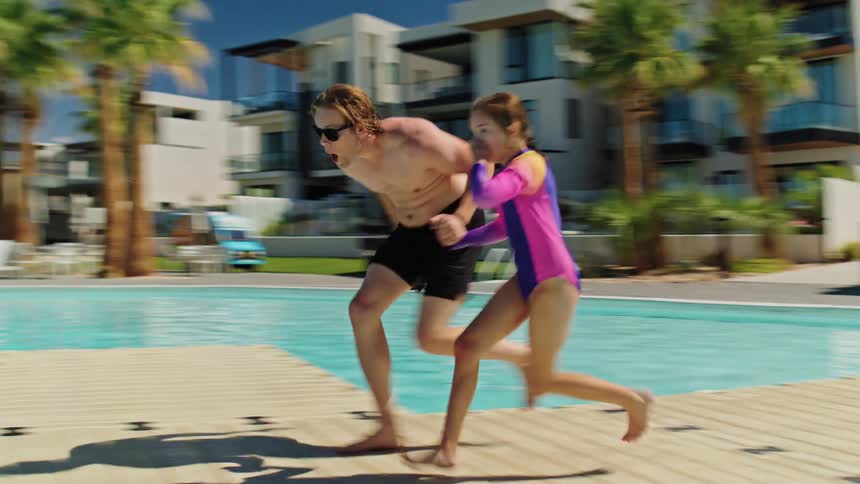 People run and jump in the pool together
