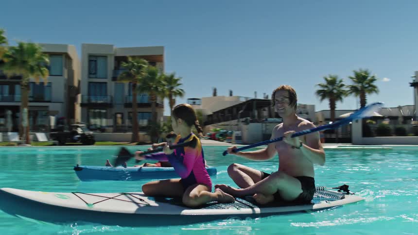 The family kayak in the pool at the resort