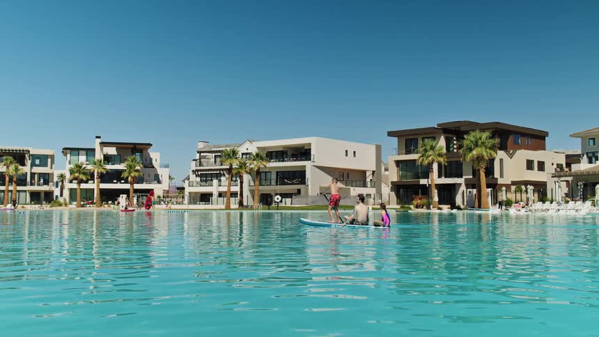 Children are having fun in the huge swimming pool