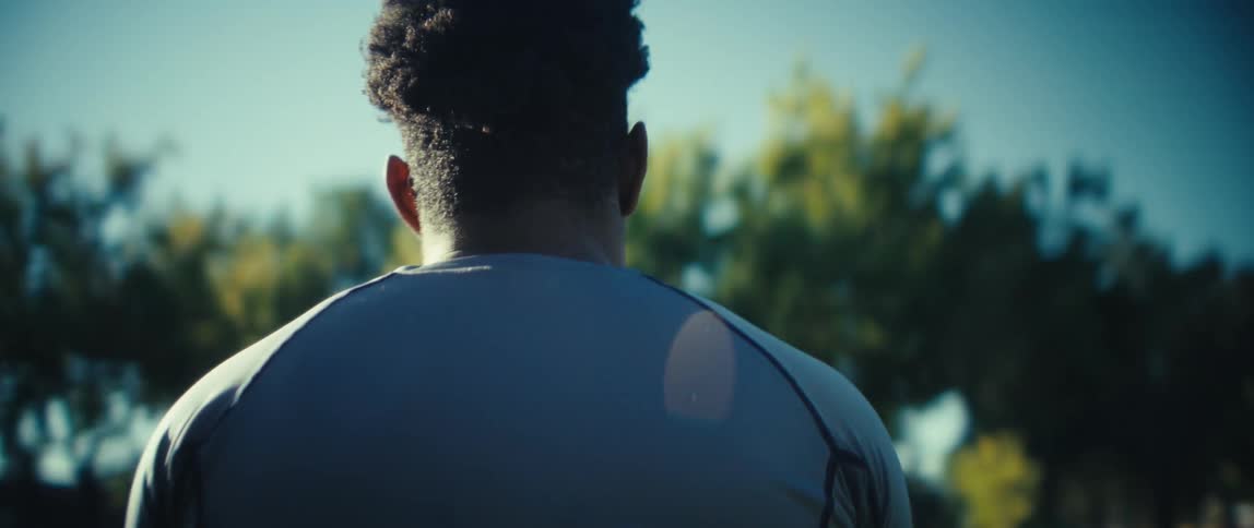 The man tosses around a football in the park