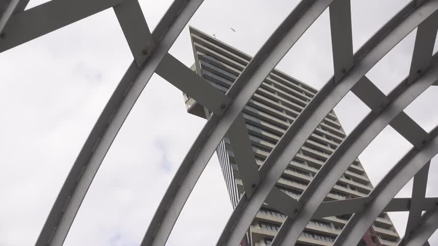 View of a tall skyscraper in a cloudy sky