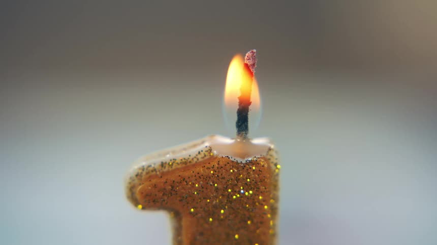 The candle slowly melts on the birthday cake