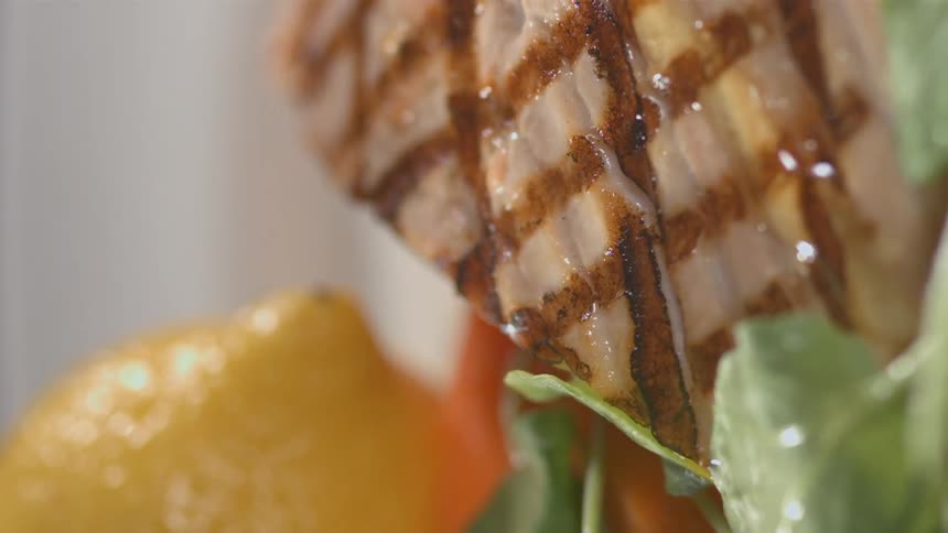 Vegetables and meat are drizzled with a sauce