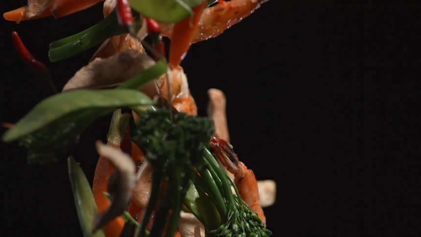 Food is tossed in a wok