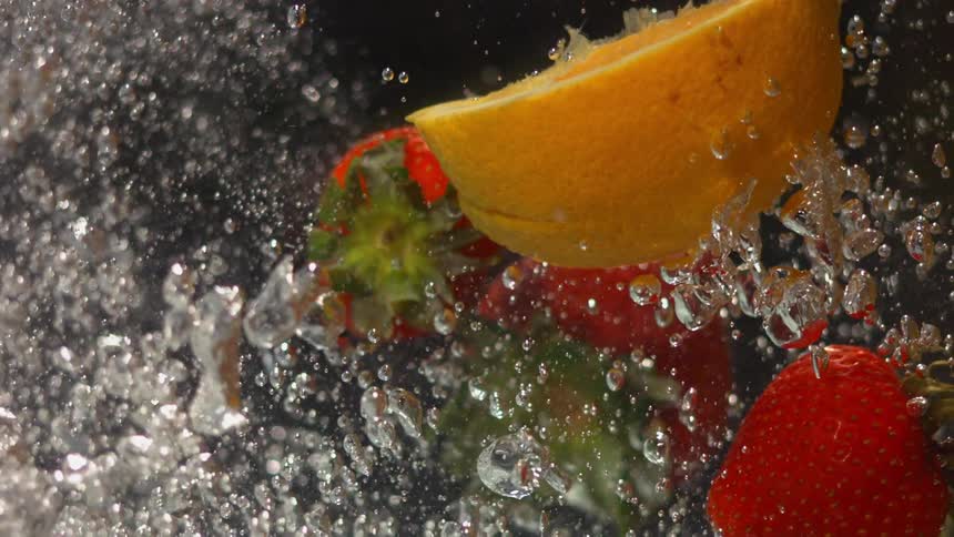 Fruit is splashing in the water together