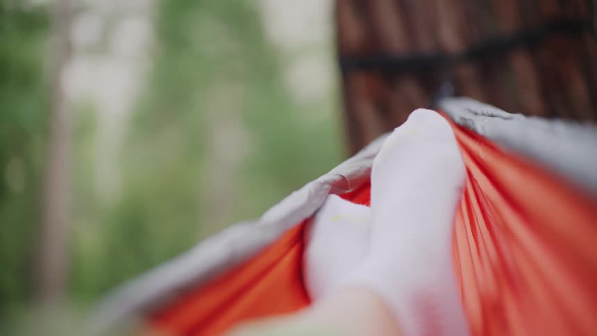The person rocks in the hammock