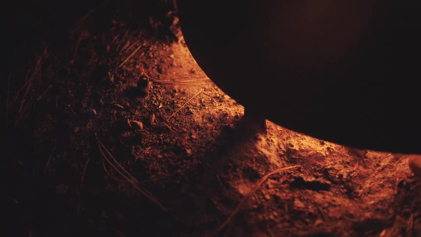 Light from a flame shining on the ground
