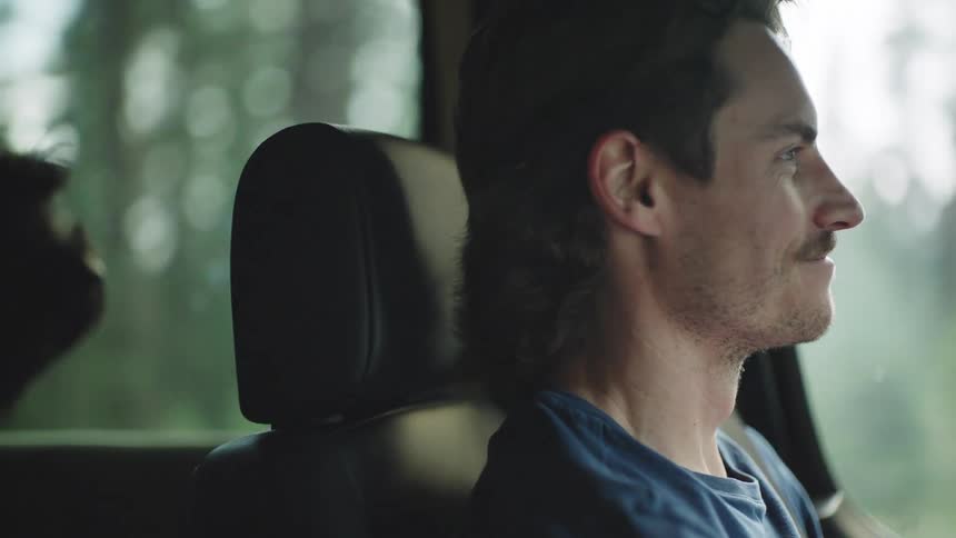 The man drives with his dog in the car