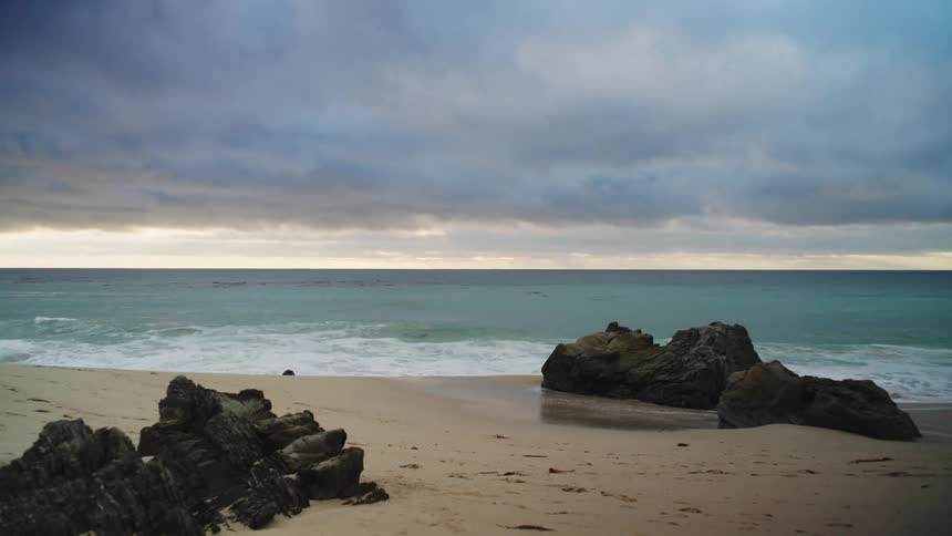 Sea weaves breaking at the beach outdoors during dusk or dawn