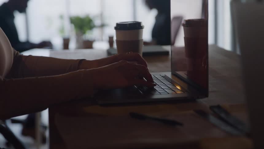 Pair of hands typing on a laptop