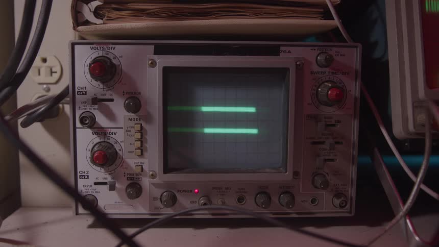 The display has lines moving on the oscilloscope