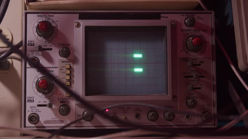 Tektronix analog oscilloscope displays two horizontal green traces on grid screen