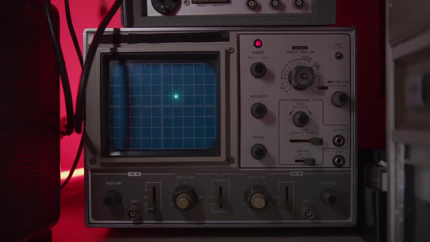 An old piece of equipment has a dot moving across the screen