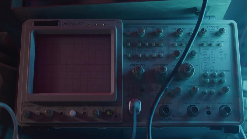 Old oscilloscope panel illuminated by blue light