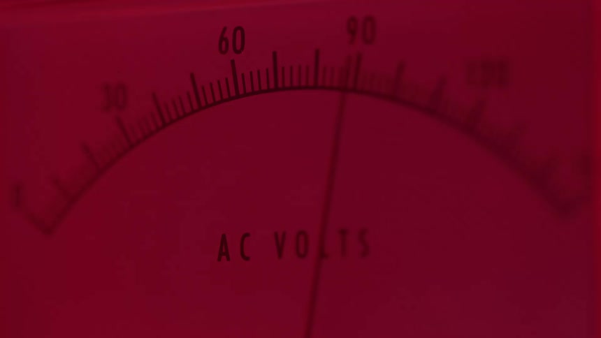Analog voltmeter scale illuminated by intense red light
